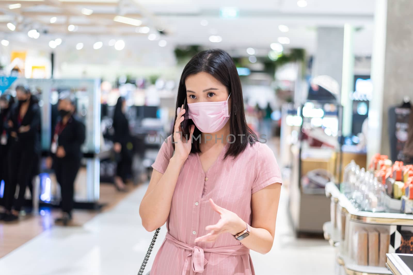 An Asian woman talking and shopping in the shopping mall after o by animagesdesign