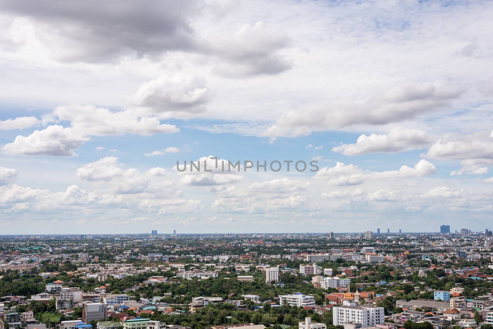 The Bangkok cityscape from skyscraper view with clouds and blue sky.