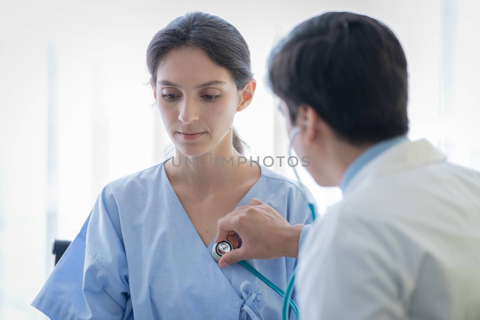 A doctor take care of sick patient woman at the hospital or medical clinic.