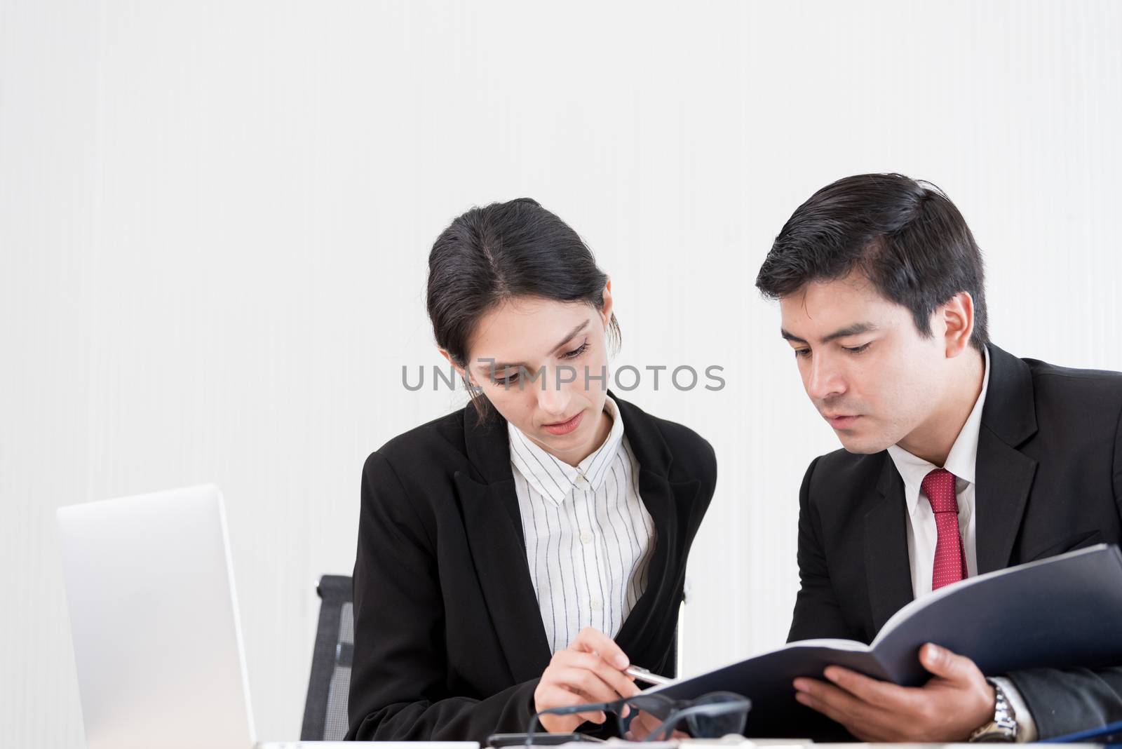 A manager and secretary working together in the office.