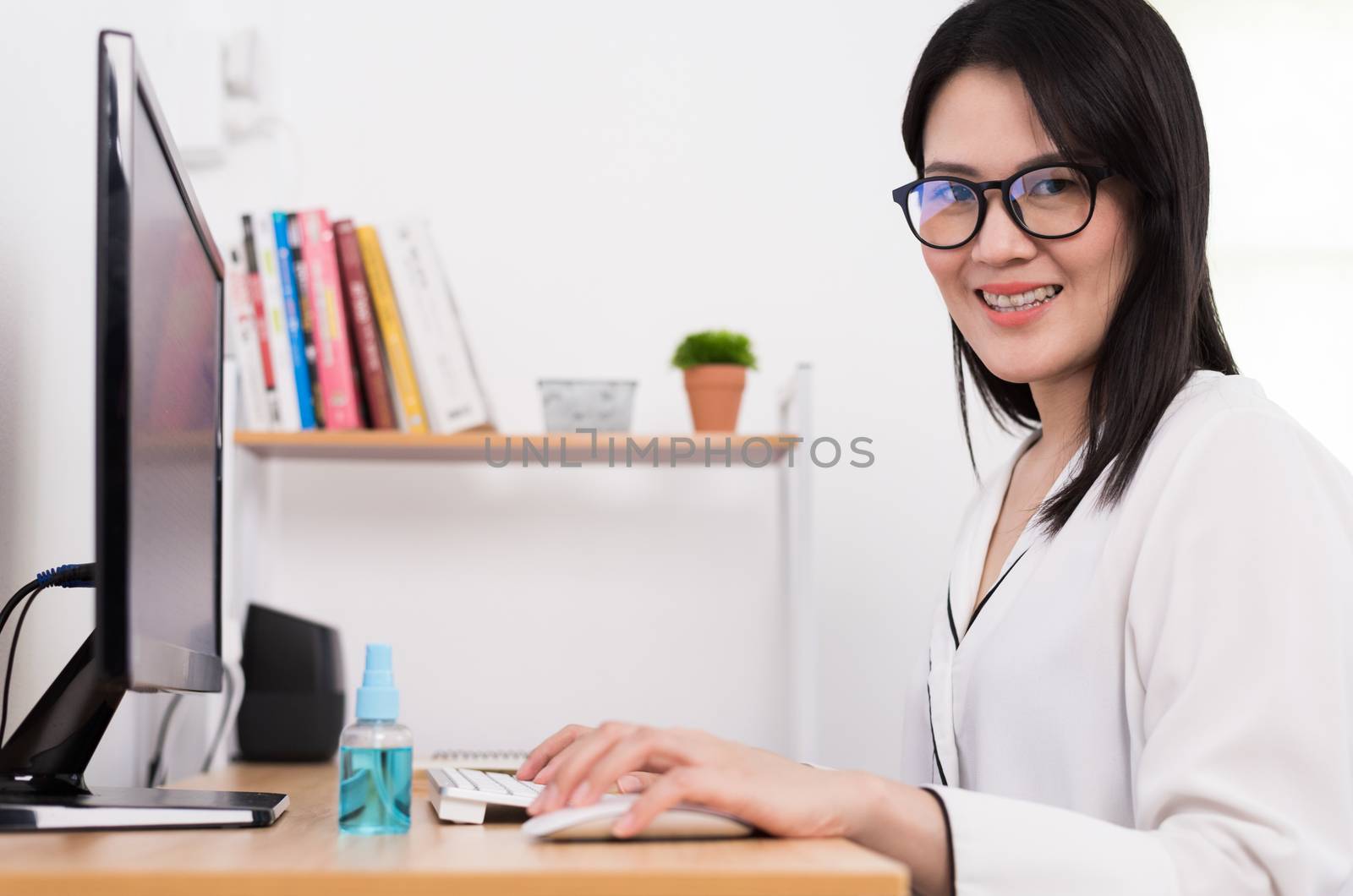 A beautiful Asian businesswoman and cleaner gel to protect COVID-19 before start working from home with safety and happiness.