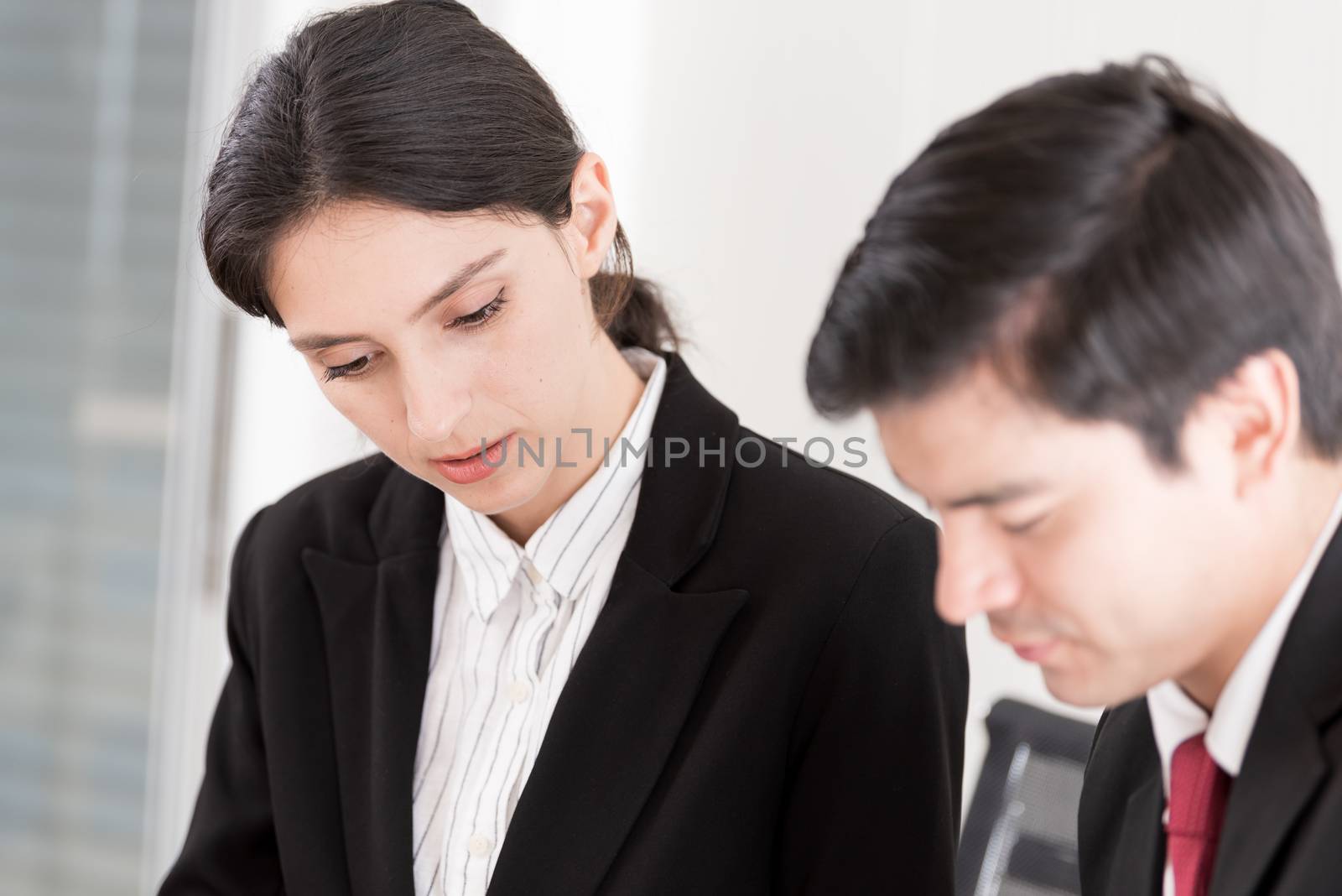 A manager and secretary working together in the office.