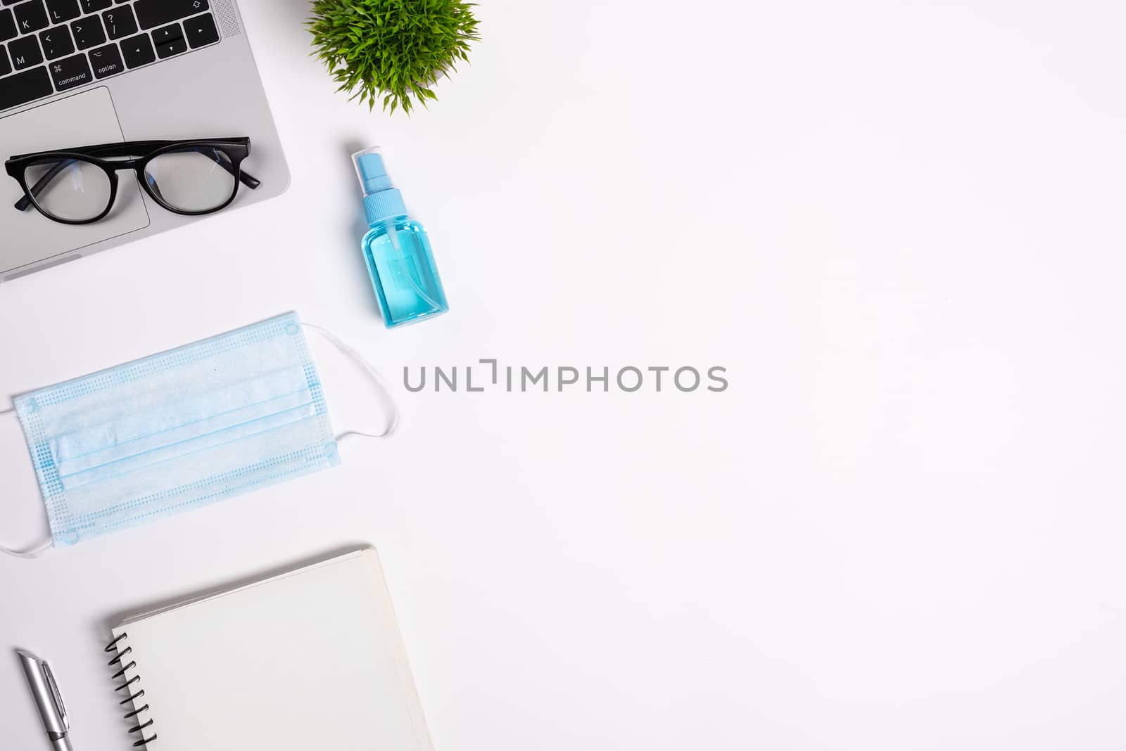 The equipment to protect COVID-19, blue mask and hand cleaner gel for preparing to work from home Isolated on white background concept.