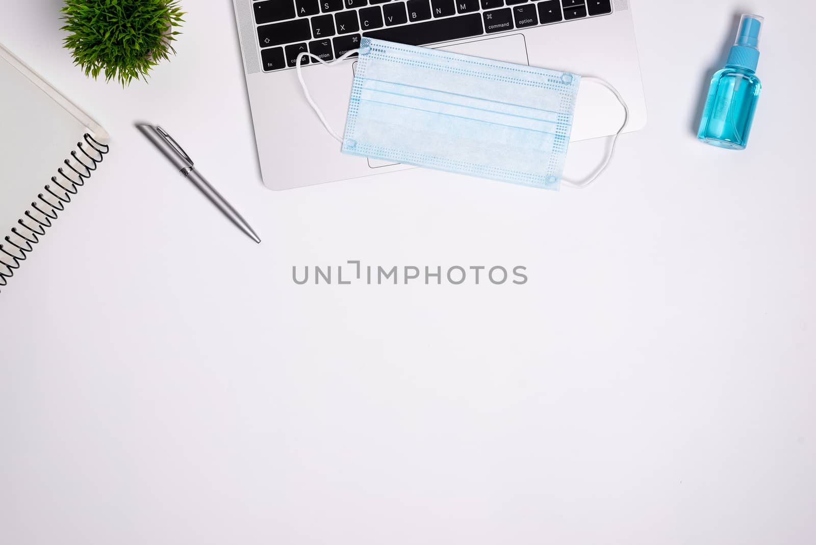 The equipment to protect COVID-19, blue mask and hand cleaner gel for preparing to work from home Isolated on white background concept.