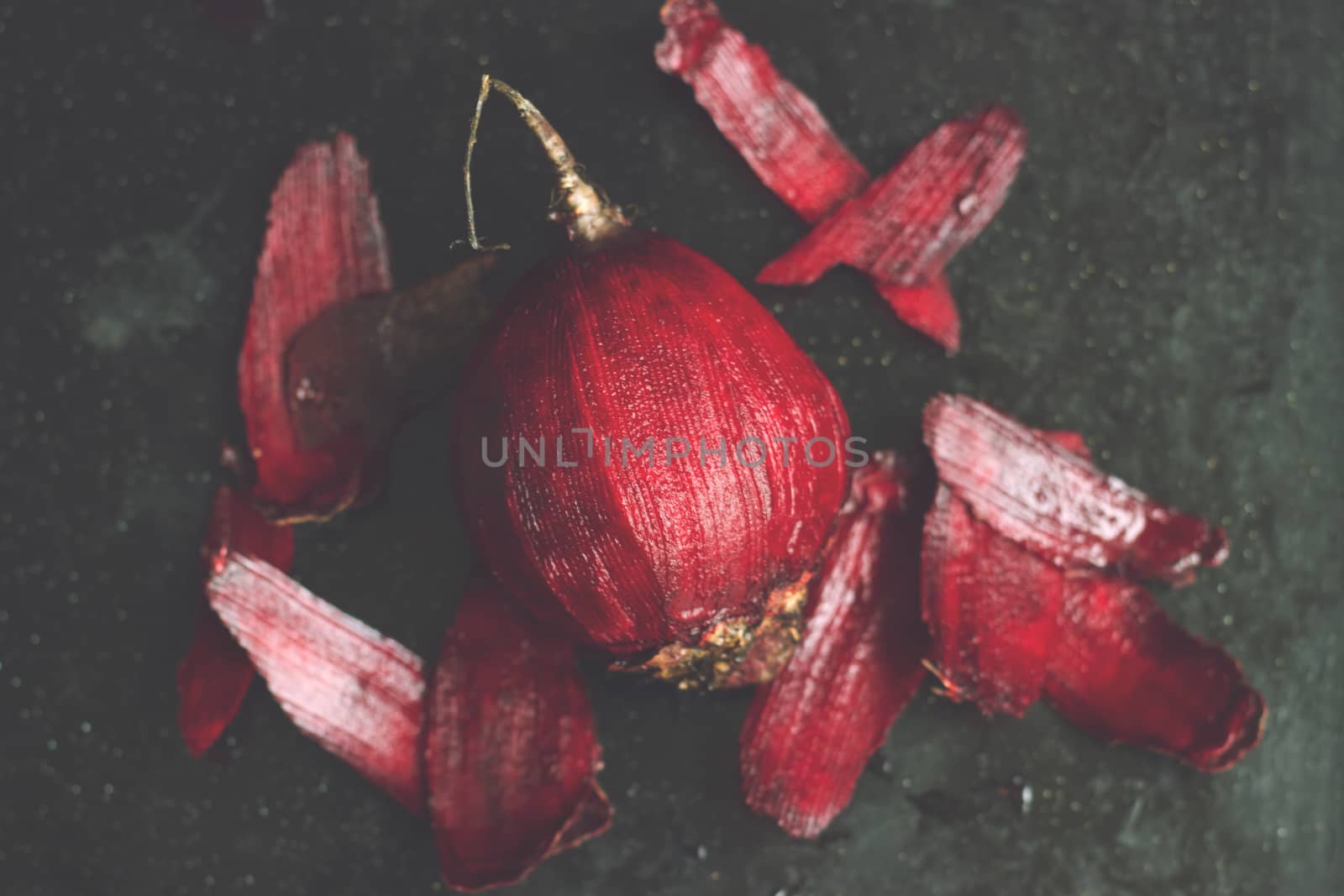Peeled beetroot on black background