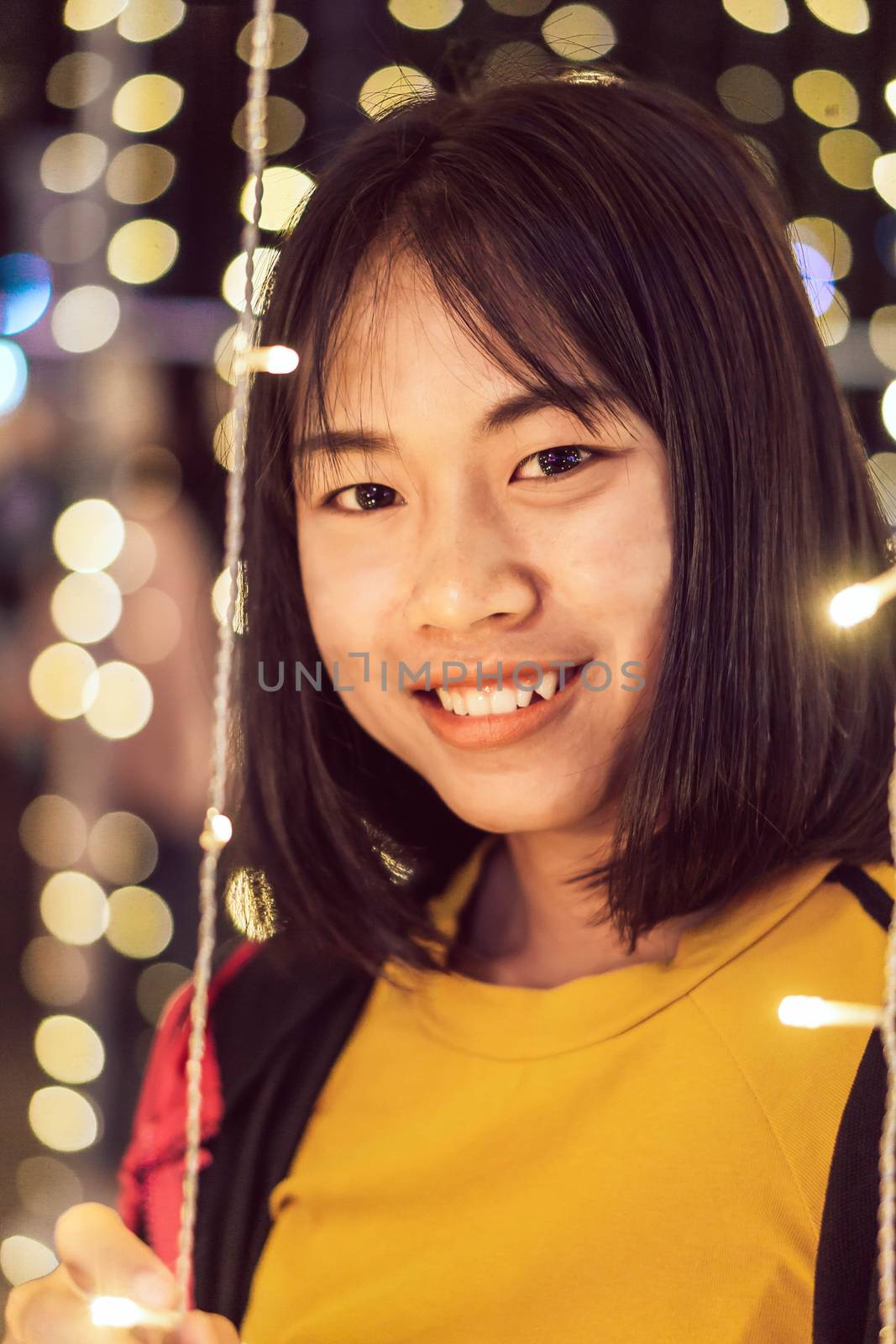 Asian girl smileing with bokeh light in christmas day, selective focus