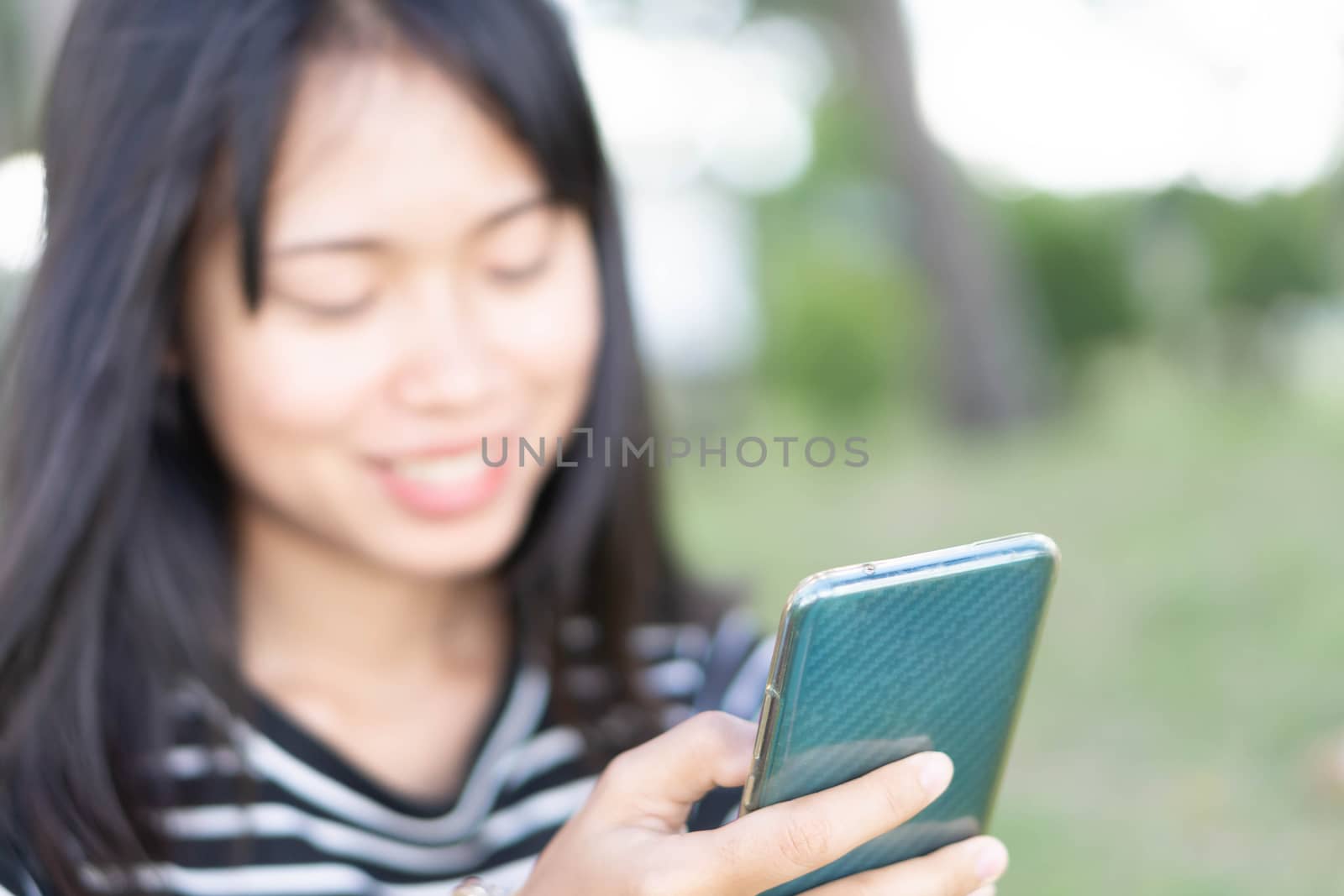 Closeup woman hand playing smartphone mobile with relaxing feell by pt.pongsak@gmail.com