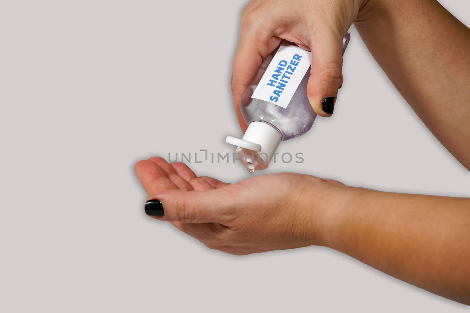 Female holds a bottle for handrubs & pours liquid, alternative to soap washing, used as hand disinfectant to kill bacteria.