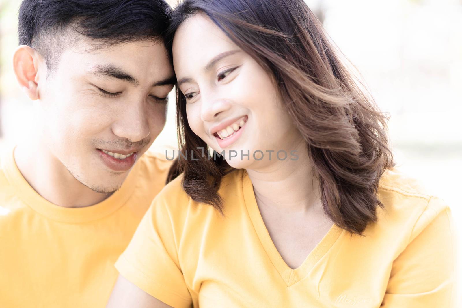 Couple happiness fun concept. Happy young couple embracing laughing in the garden