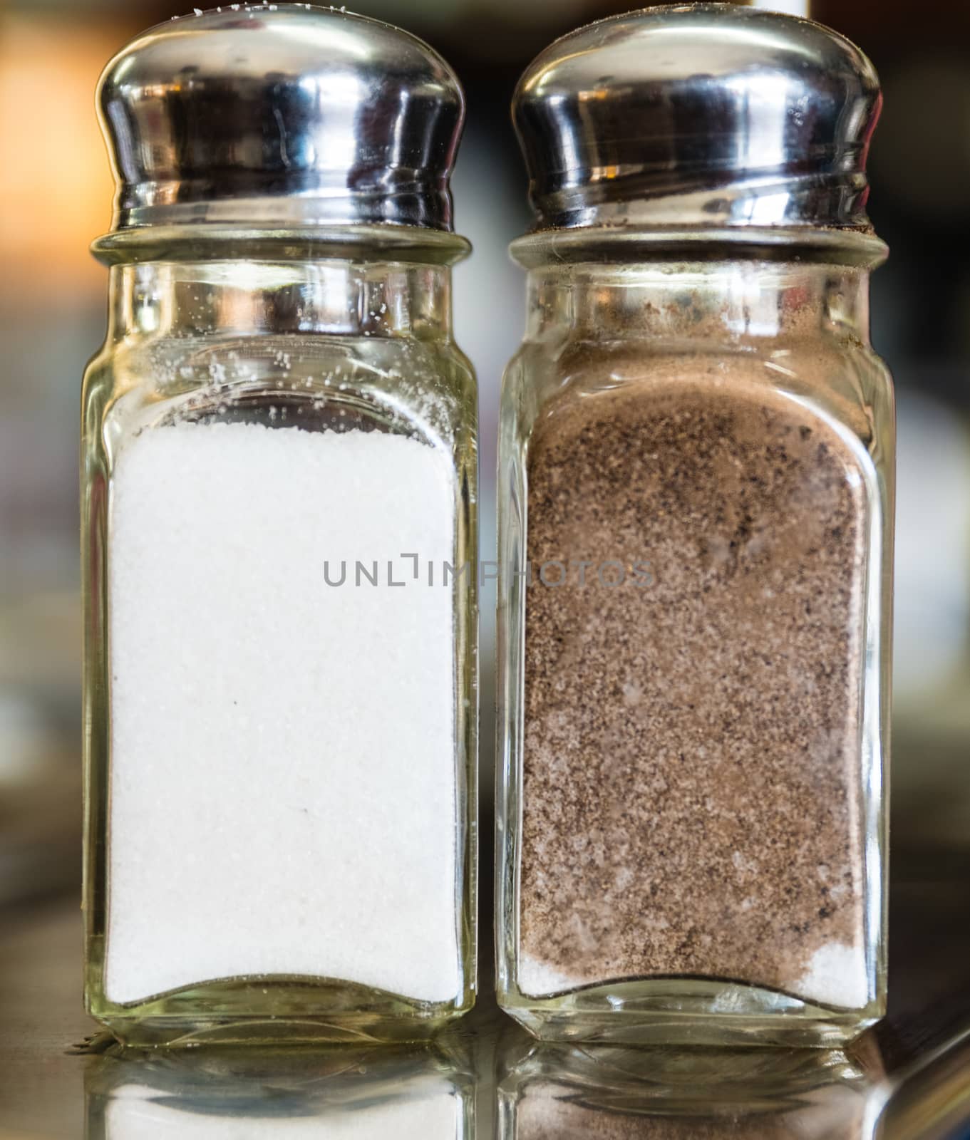 A salt and pepper shakers on a marble table.