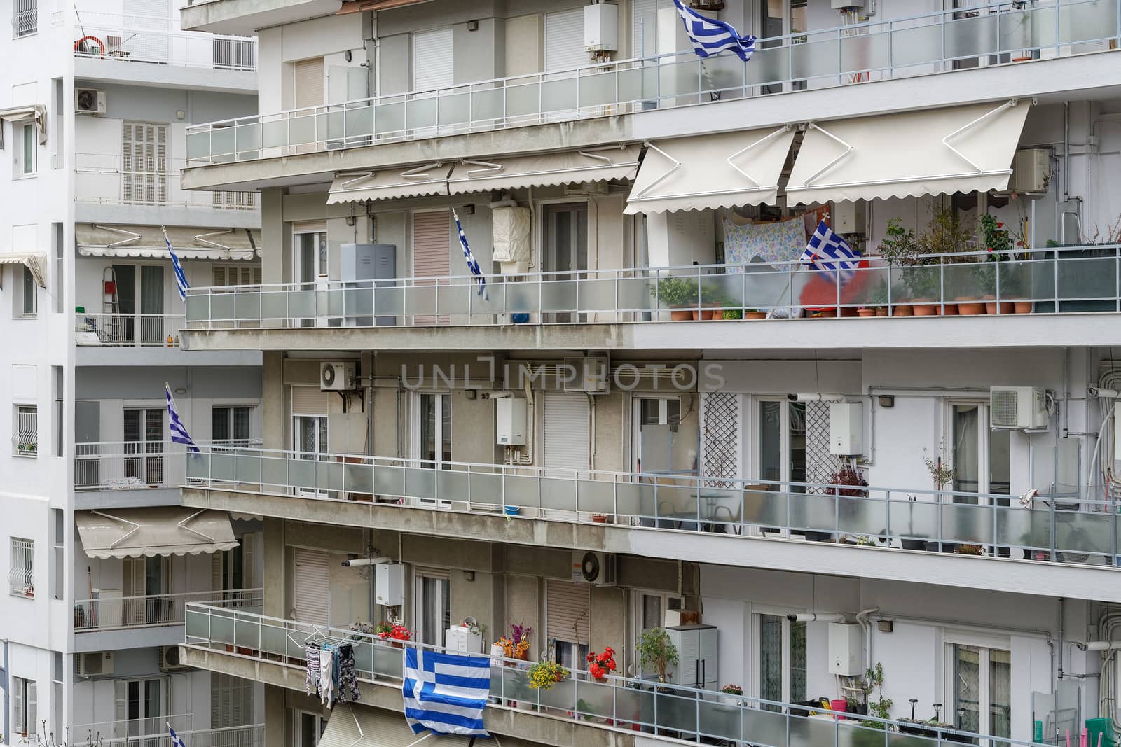 Greek flags waving on balconies for a national celebration. by bestravelvideo