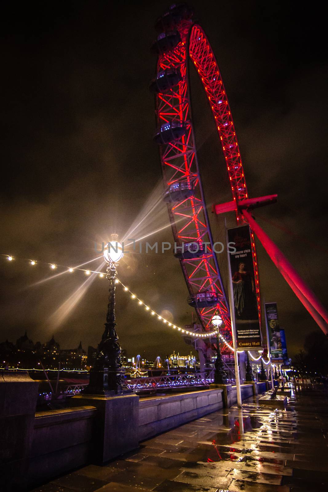 The London Eye illuminated at night in red