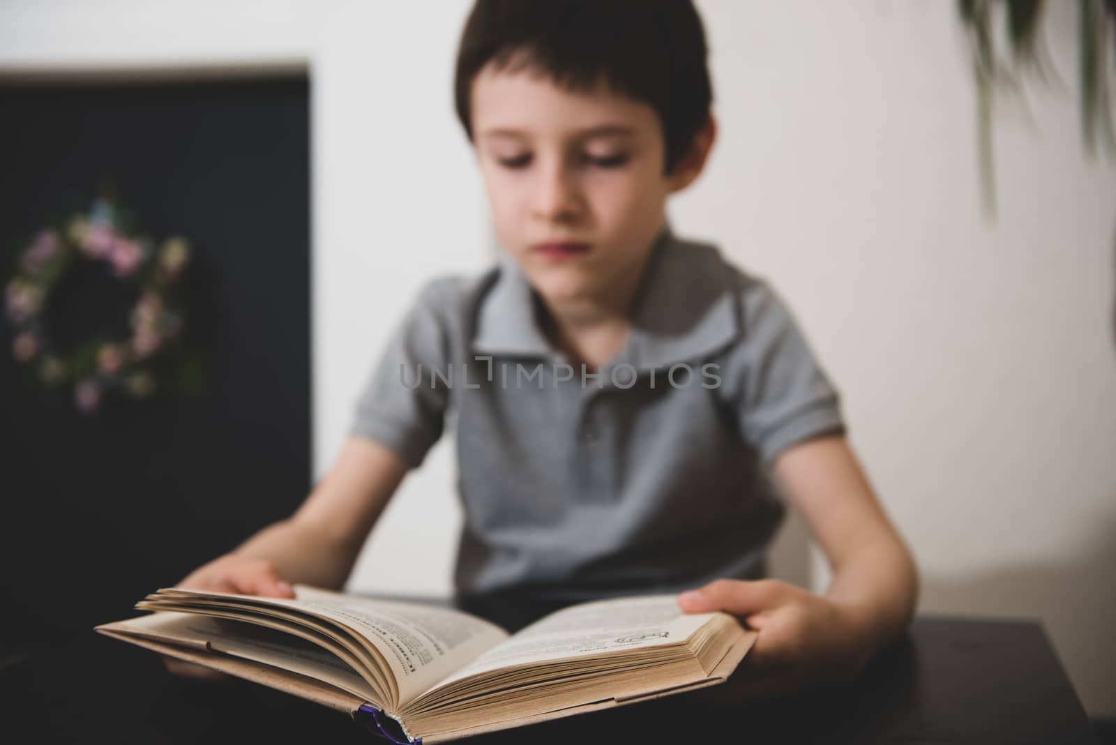 Blur image of a boy reading a book