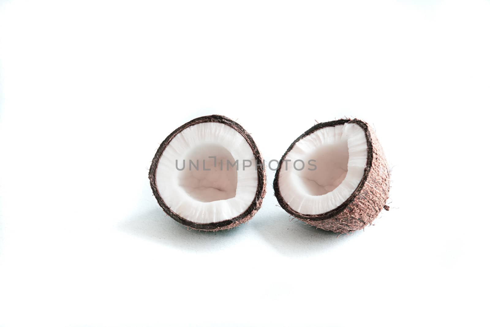 two halves of coconut isolated on a white background with empty place for text by marynkin