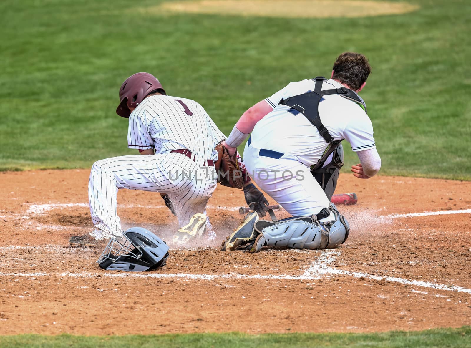 Action photo of high school baseball players making amazing plays during a baseball game