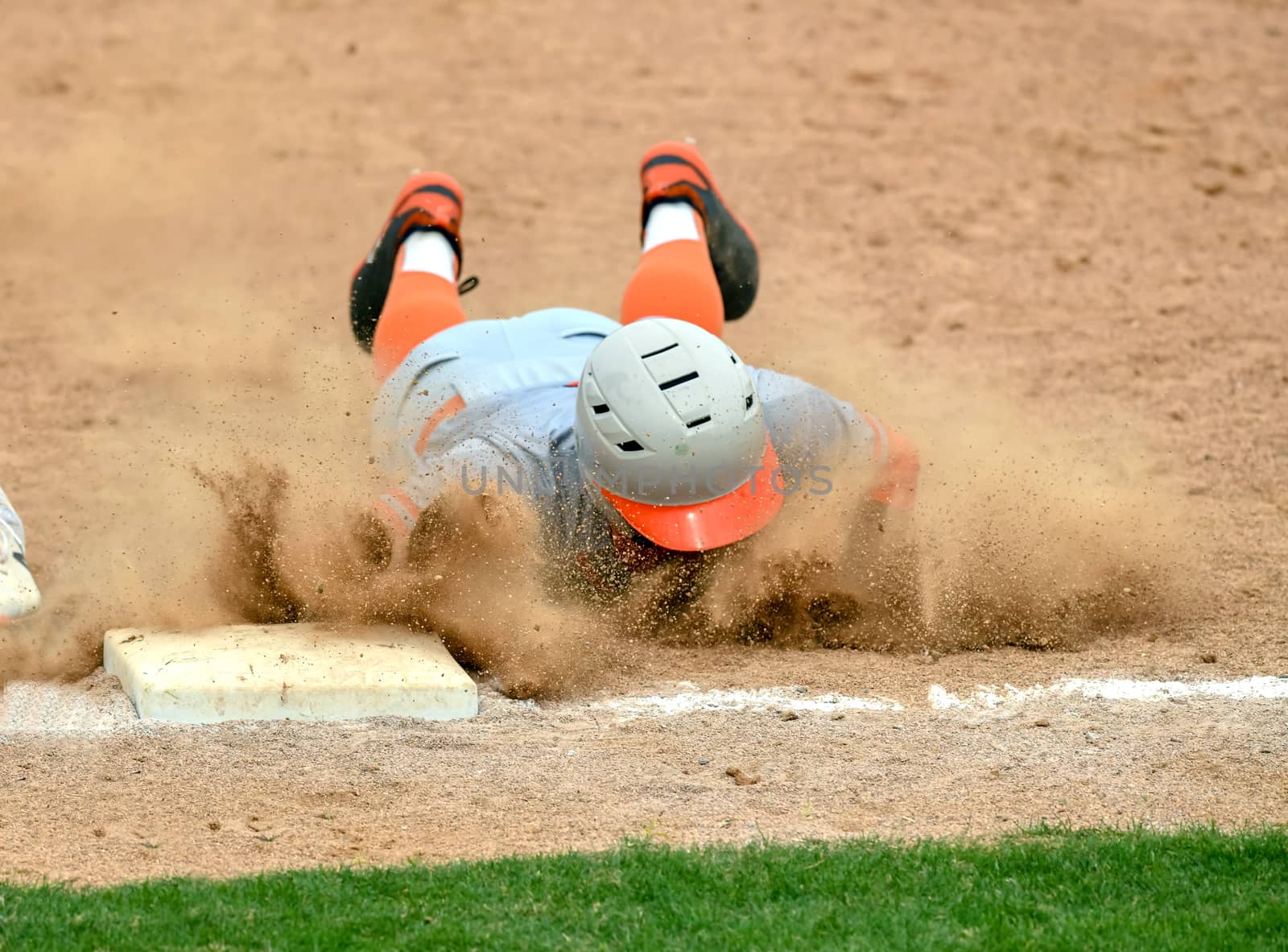 Action photo of high school baseball players making amazing plays during a baseball game