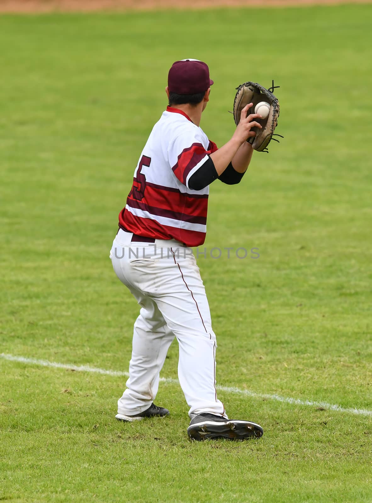 Young athletic boys playing baseball by Calomeni