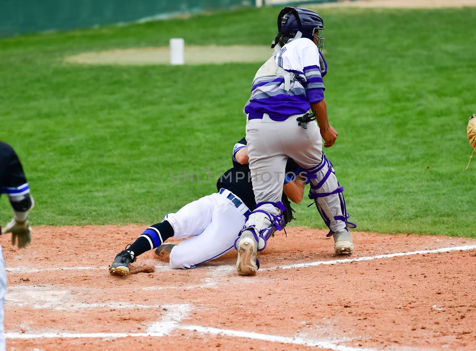 Action photo of high school baseball players making amazing plays during a baseball game