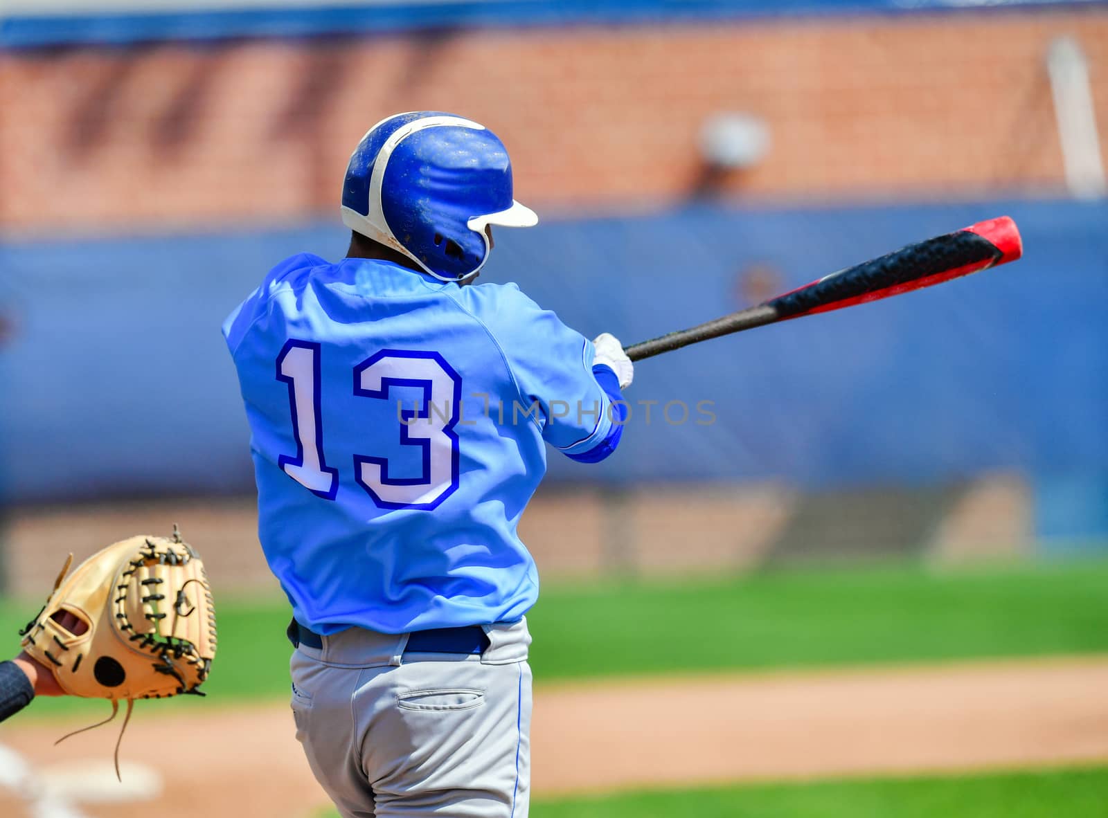 Action photo of high school baseball players making amazing plays during a baseball game