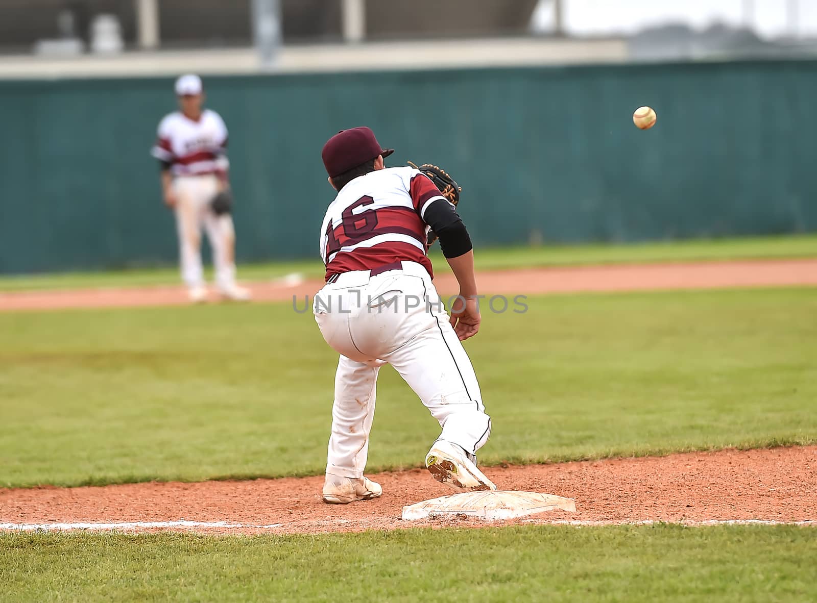 Action photo of high school baseball players making amazing plays during a baseball game