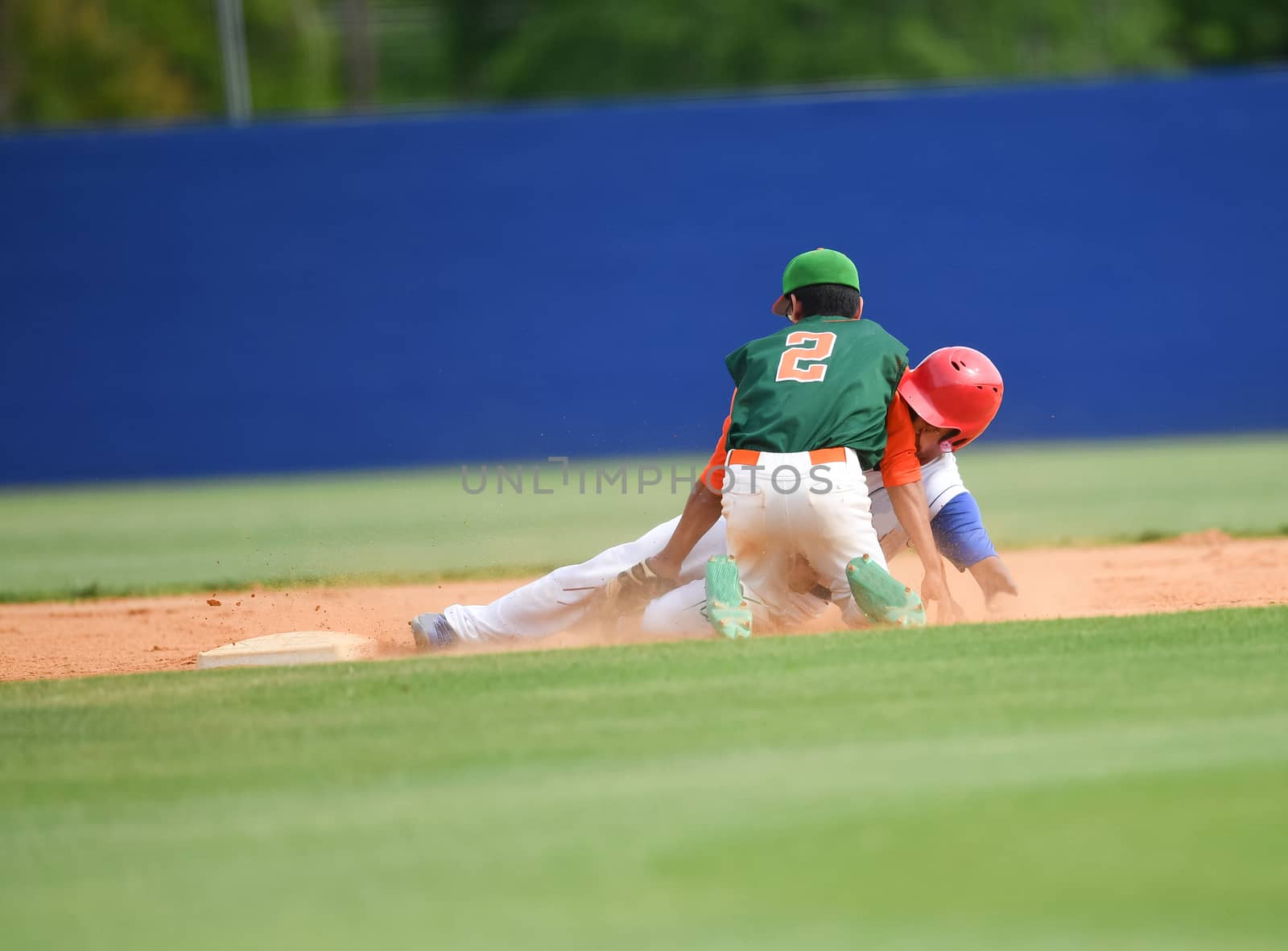 Action photo of high school baseball players making amazing plays during a baseball game