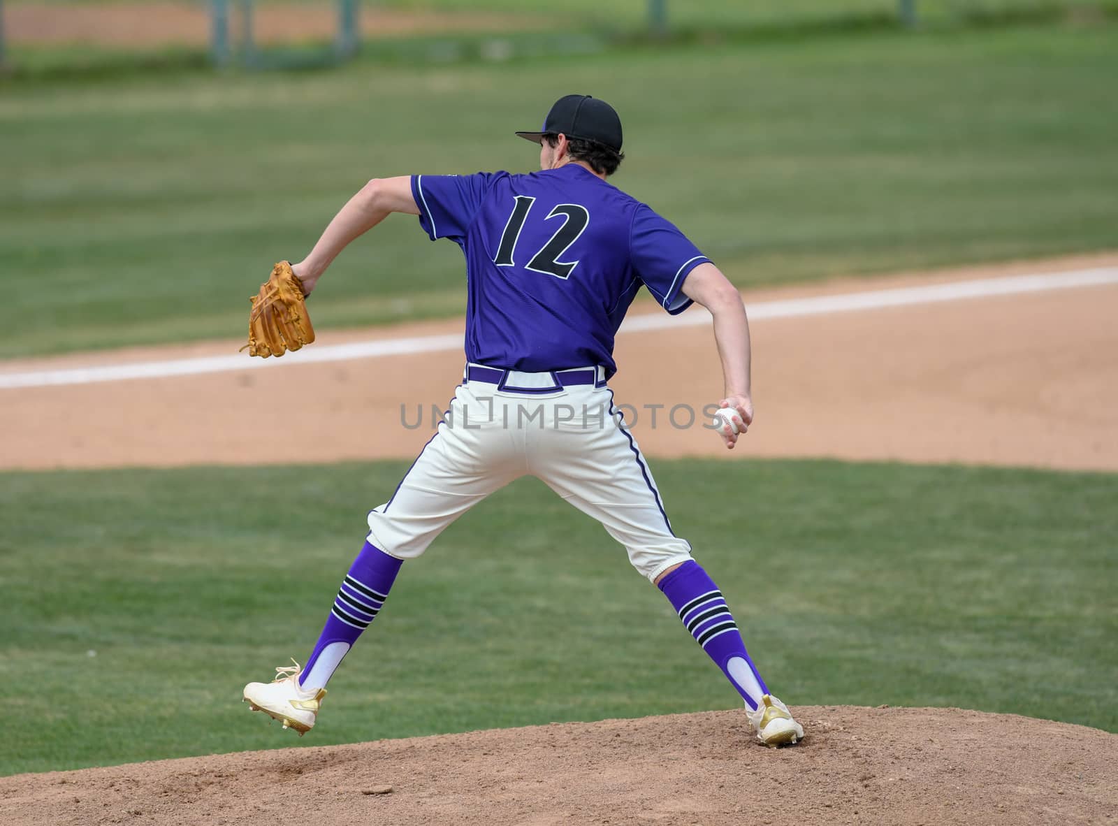 Young athletic boy playing baseball by Calomeni