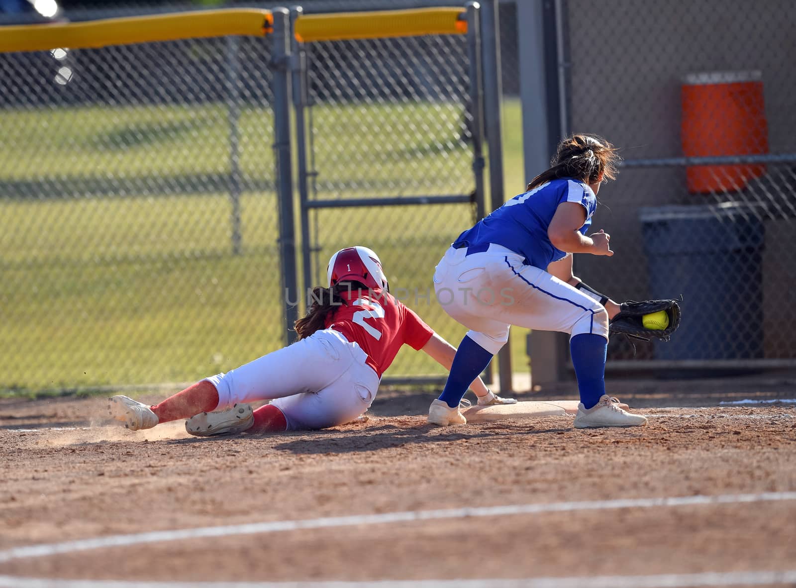 Action photo of high school baseball players making amazing plays during a baseball game