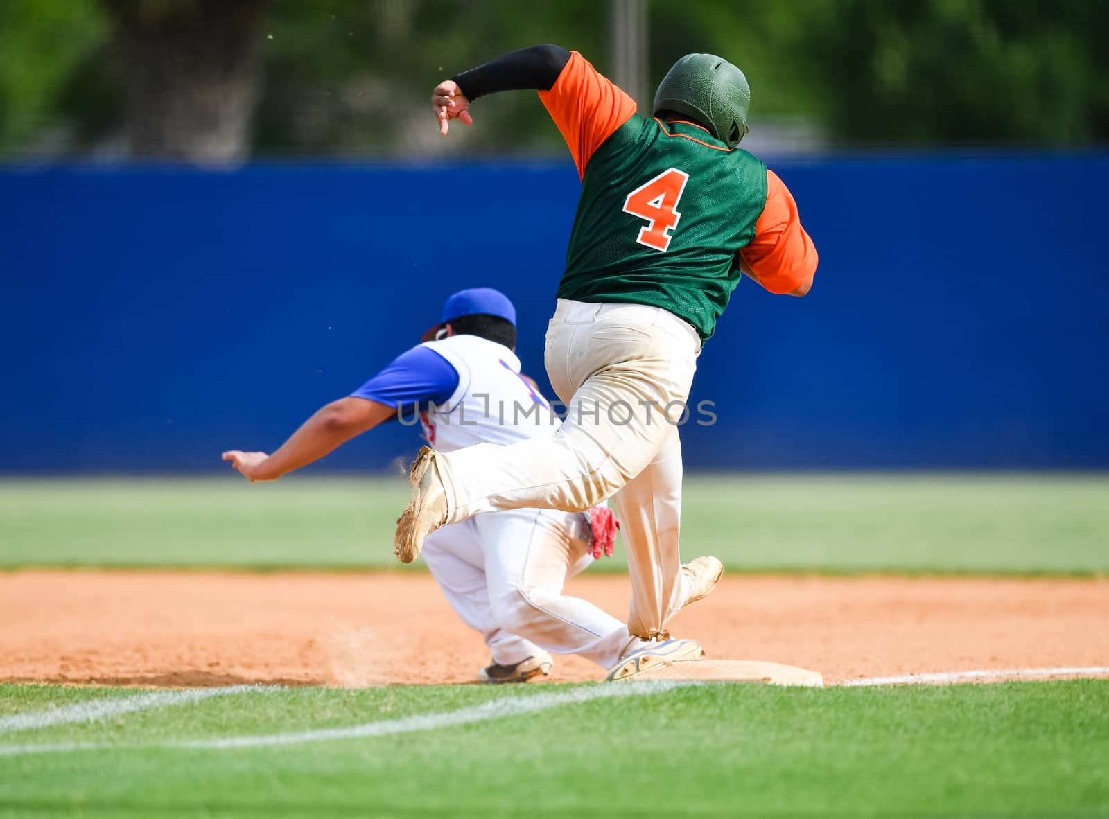 Action photo of high school baseball players making amazing plays during a baseball game