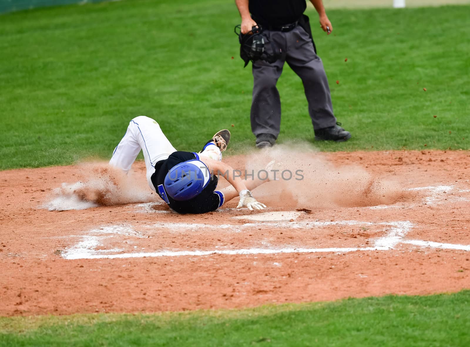 Action photo of high school baseball players making amazing plays during a baseball game