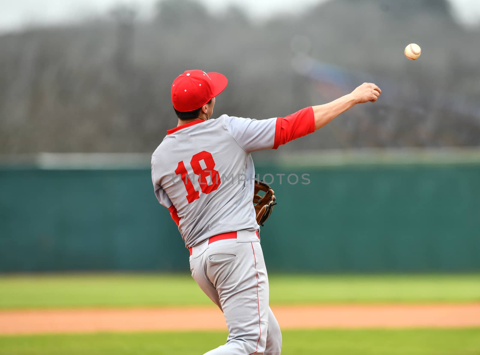 Action photo of high school baseball players making amazing plays during a baseball game