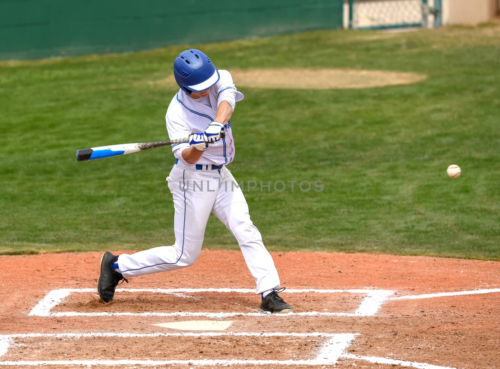 Action photo of high school baseball players making amazing plays during a baseball game