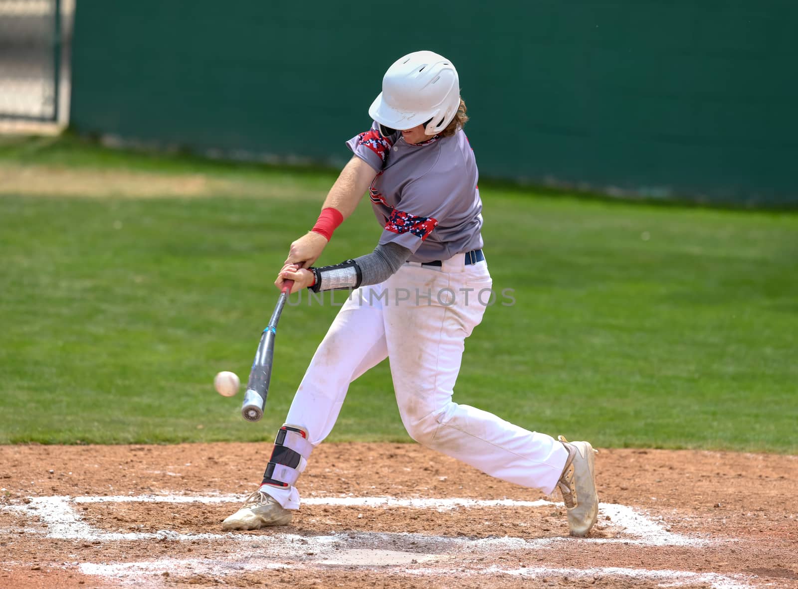 Young athletic boy playing baseball by Calomeni