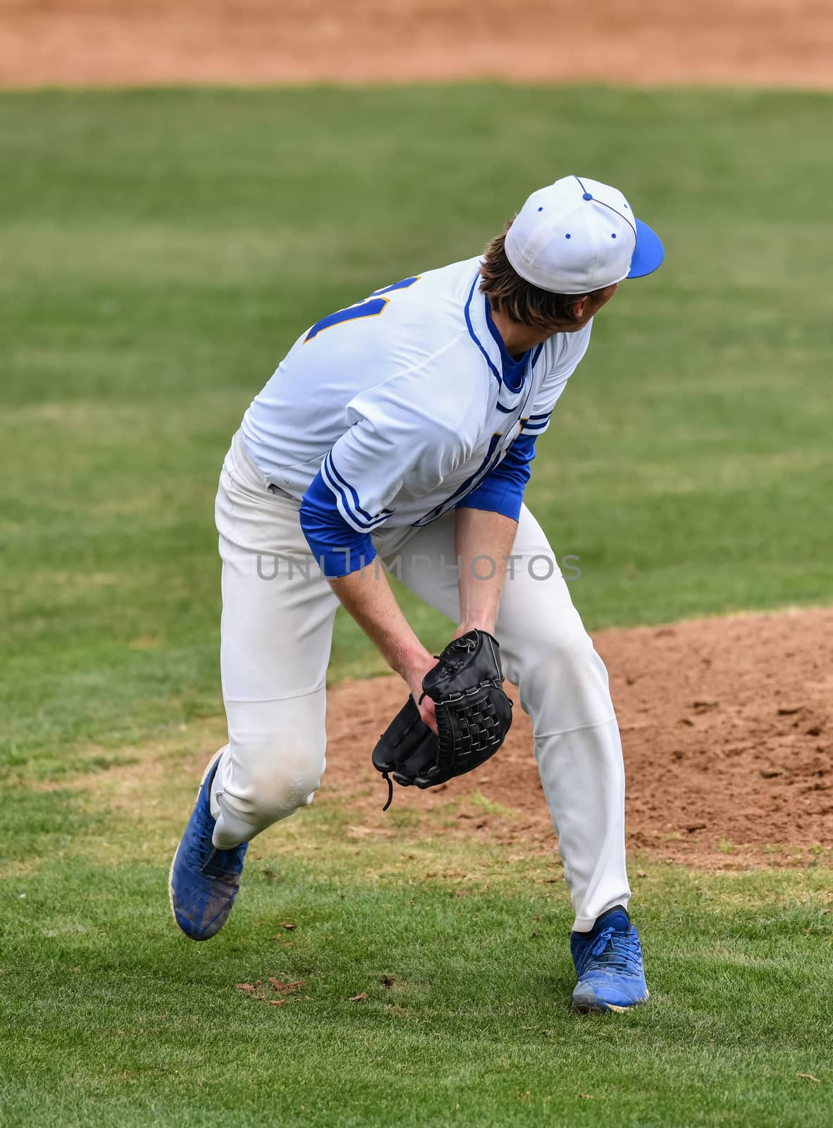 Action photo of high school baseball players making amazing plays during a baseball game