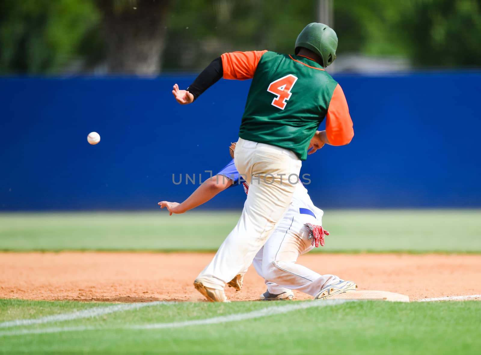 Action photo of high school baseball players making amazing plays during a baseball game