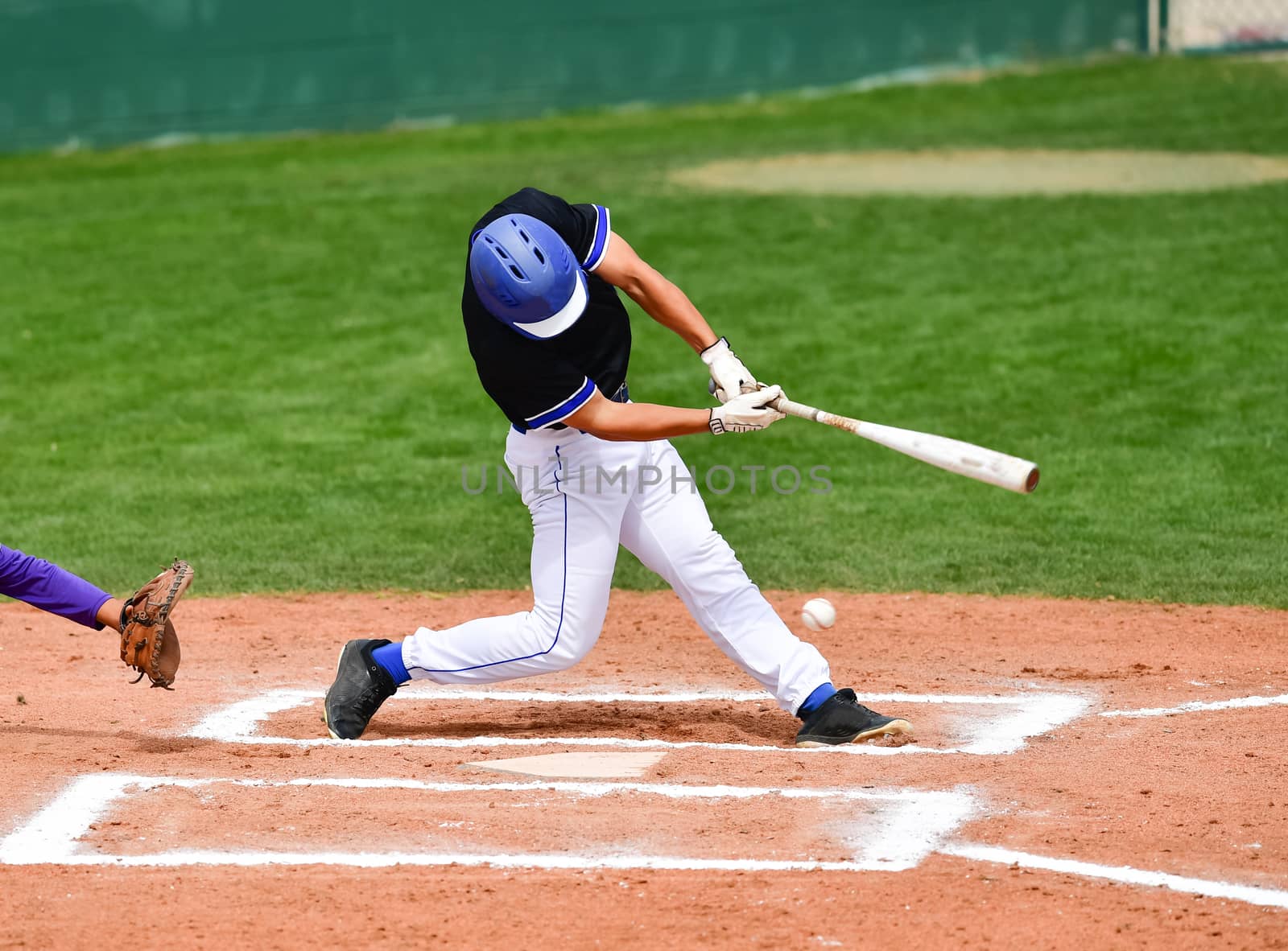 Action photo of high school baseball players making amazing plays during a baseball game