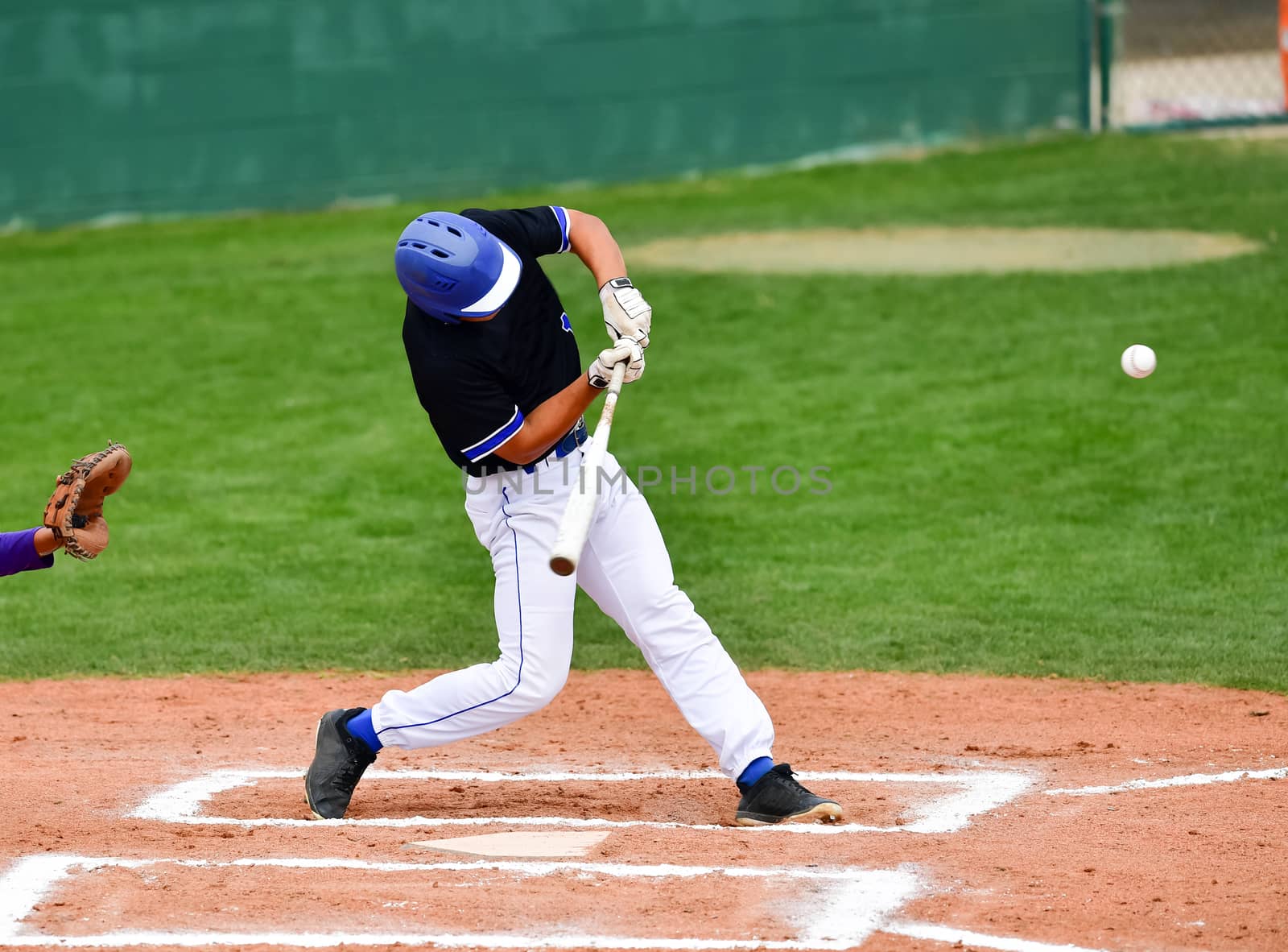 Action photo of high school baseball players making amazing plays during a baseball game