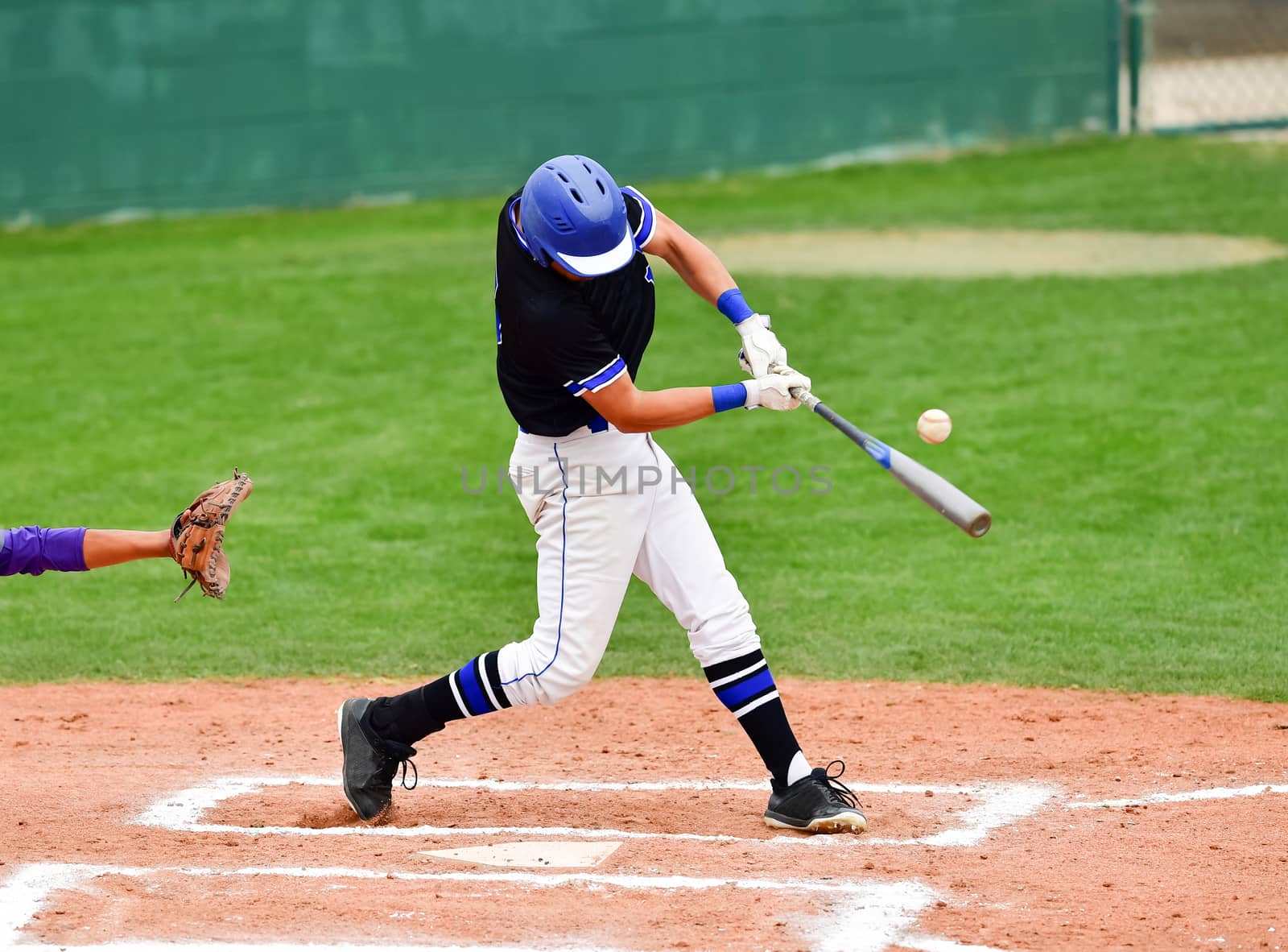 Action photo of high school baseball players making amazing plays during a baseball game