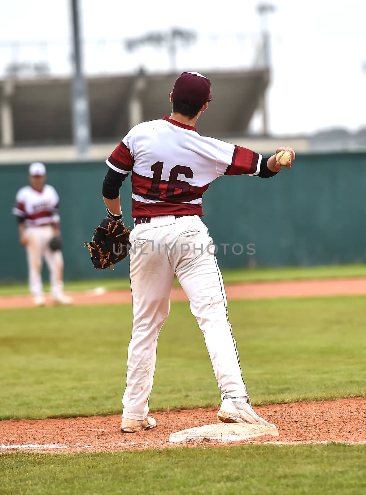 Action photo of high school baseball players making amazing plays during a baseball game