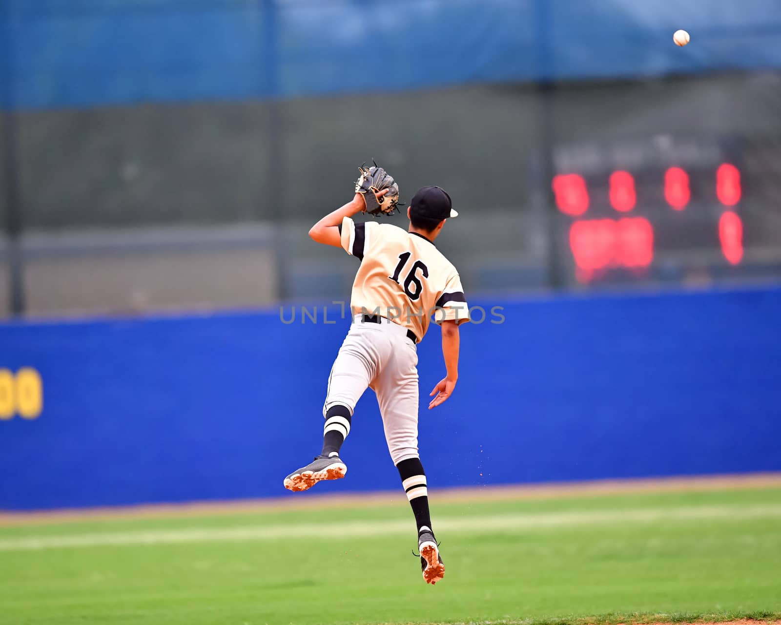 Young athletic boys playing baseball by Calomeni