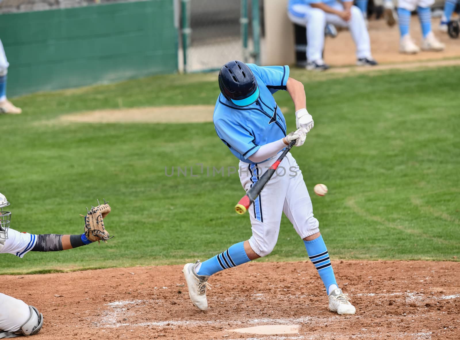 Action photo of high school baseball players making amazing plays during a baseball game