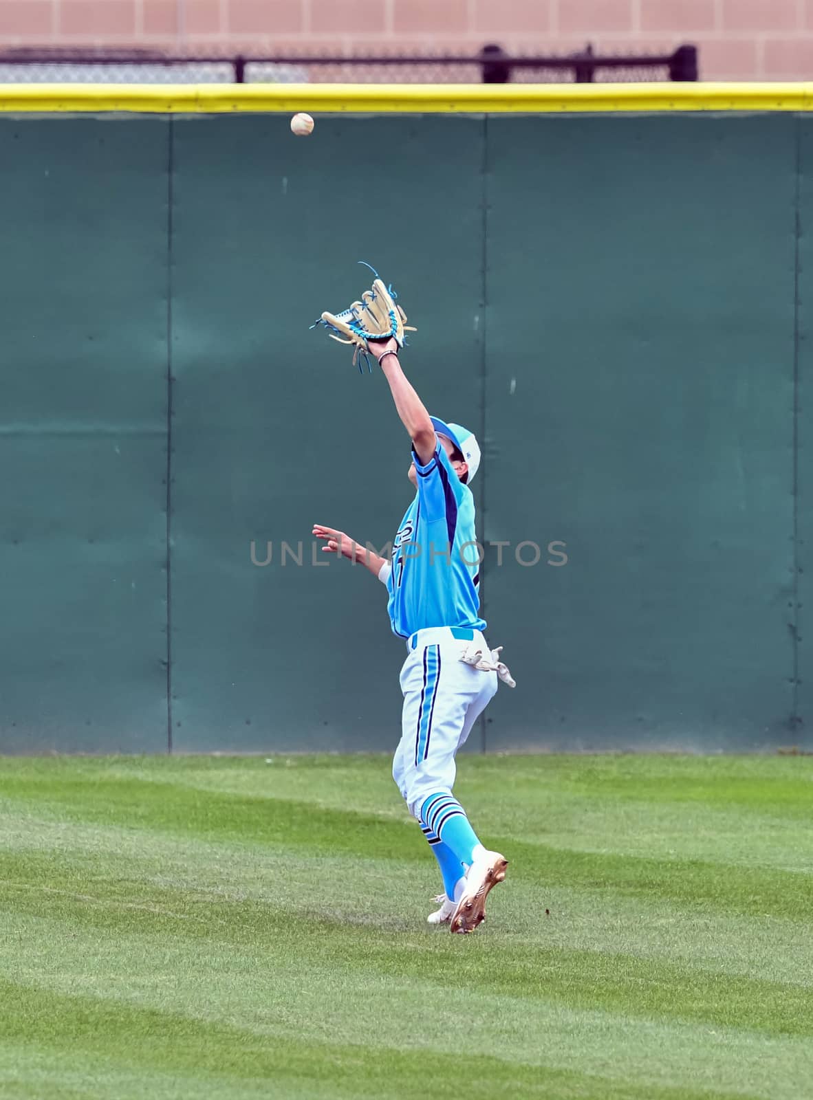 Action photo of high school baseball players making amazing plays during a baseball game