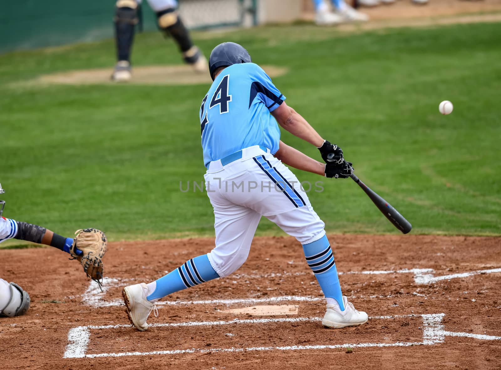 Action photo of high school baseball players making amazing plays during a baseball game