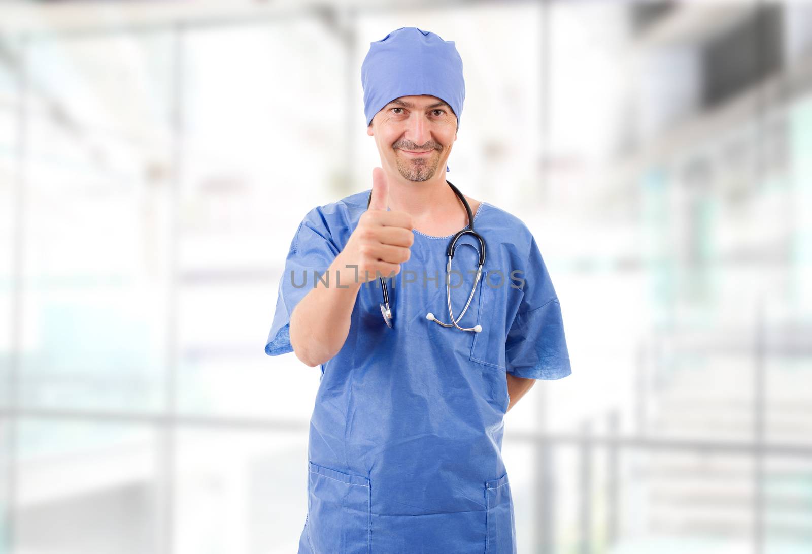 Happy male doctor showing thumbs up, at the hospital