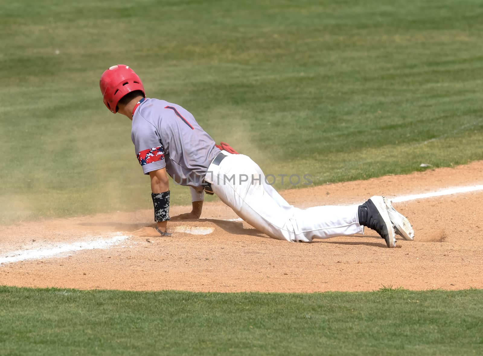 Action photo of high school baseball players making amazing plays during a baseball game