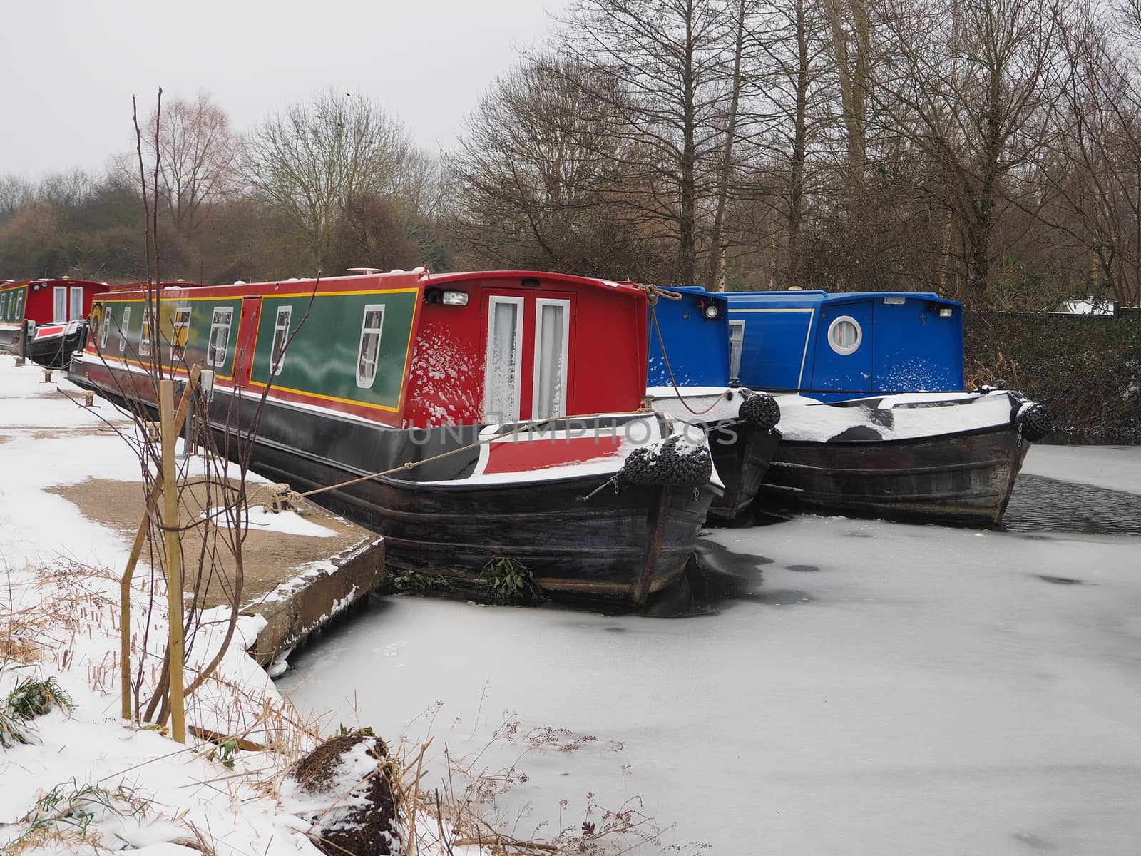 Colorful canal boats moored in icy water, Kennet and Avon Canal by PhilHarland