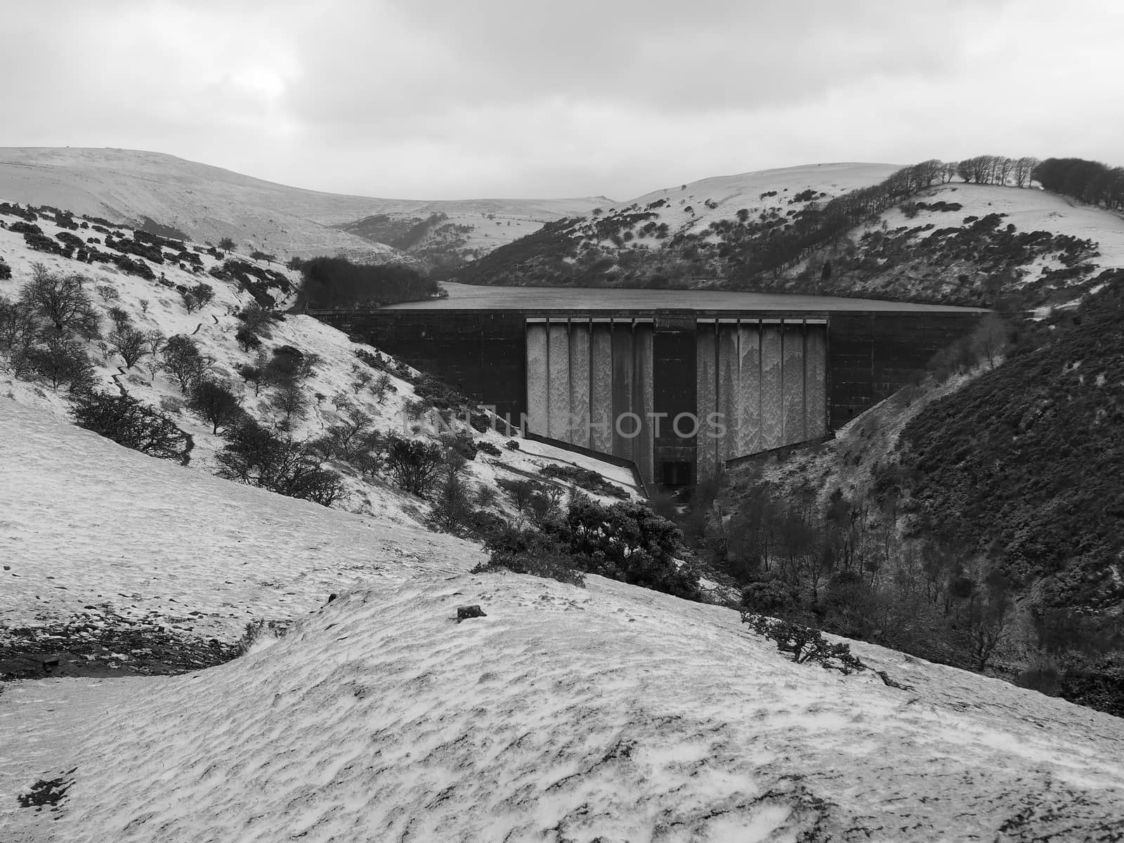 Water flowing over Meldon Dam in the snow, Meldon Reservoir, Dartmoor by PhilHarland