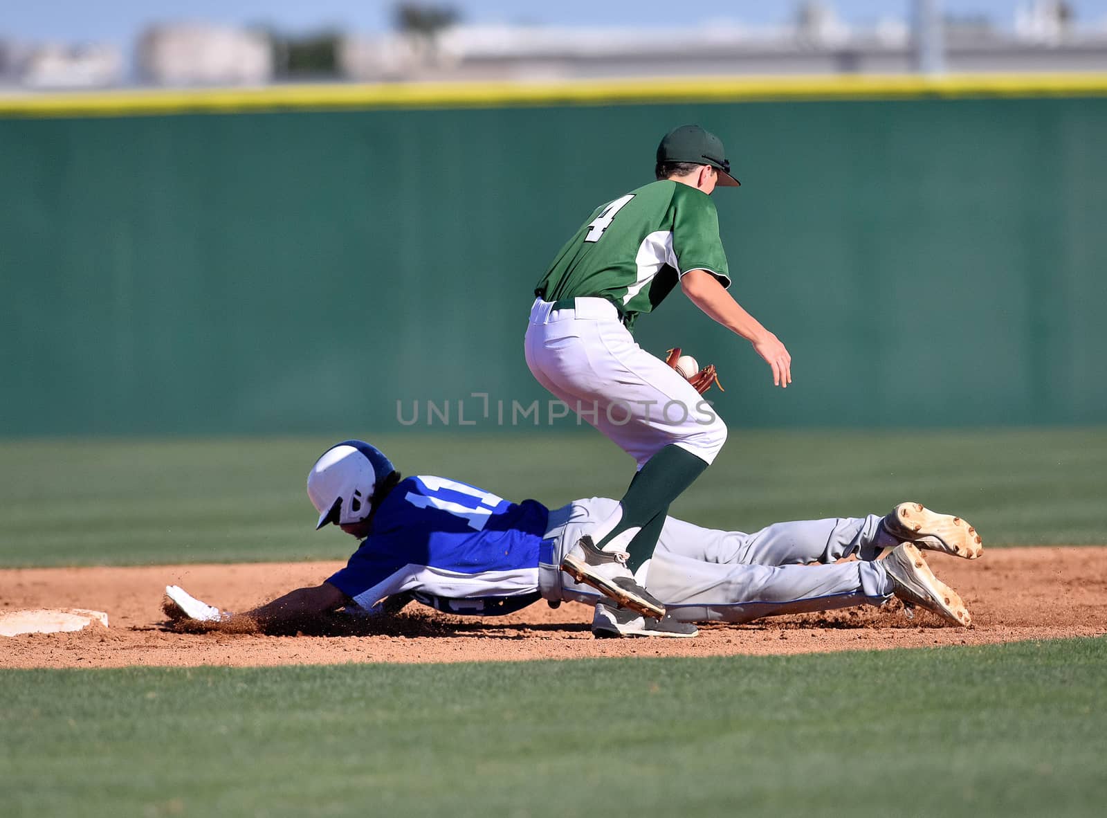 Action photo of high school baseball players making amazing plays during a baseball game