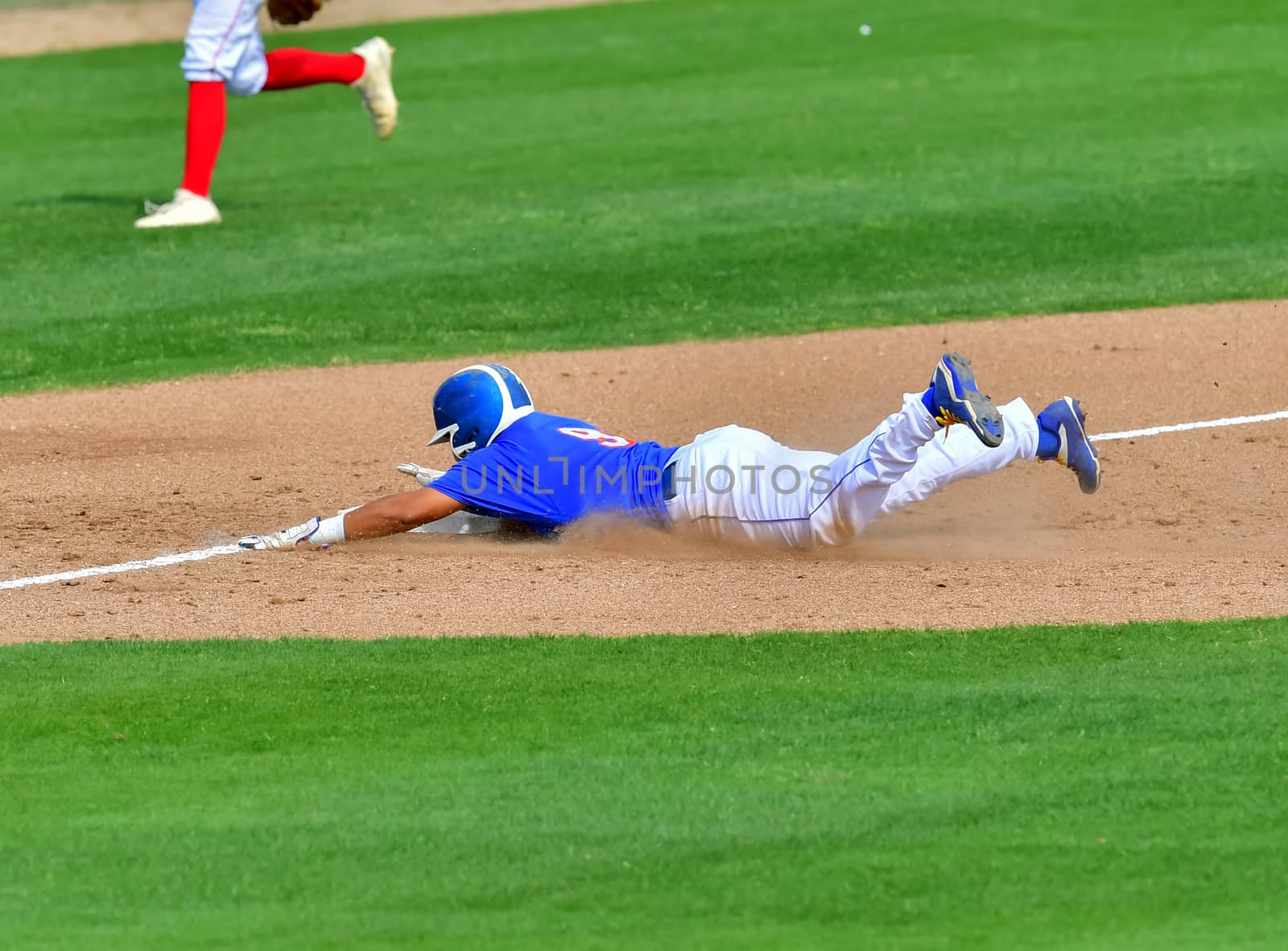 Action photo of high school baseball players making amazing plays during a baseball game