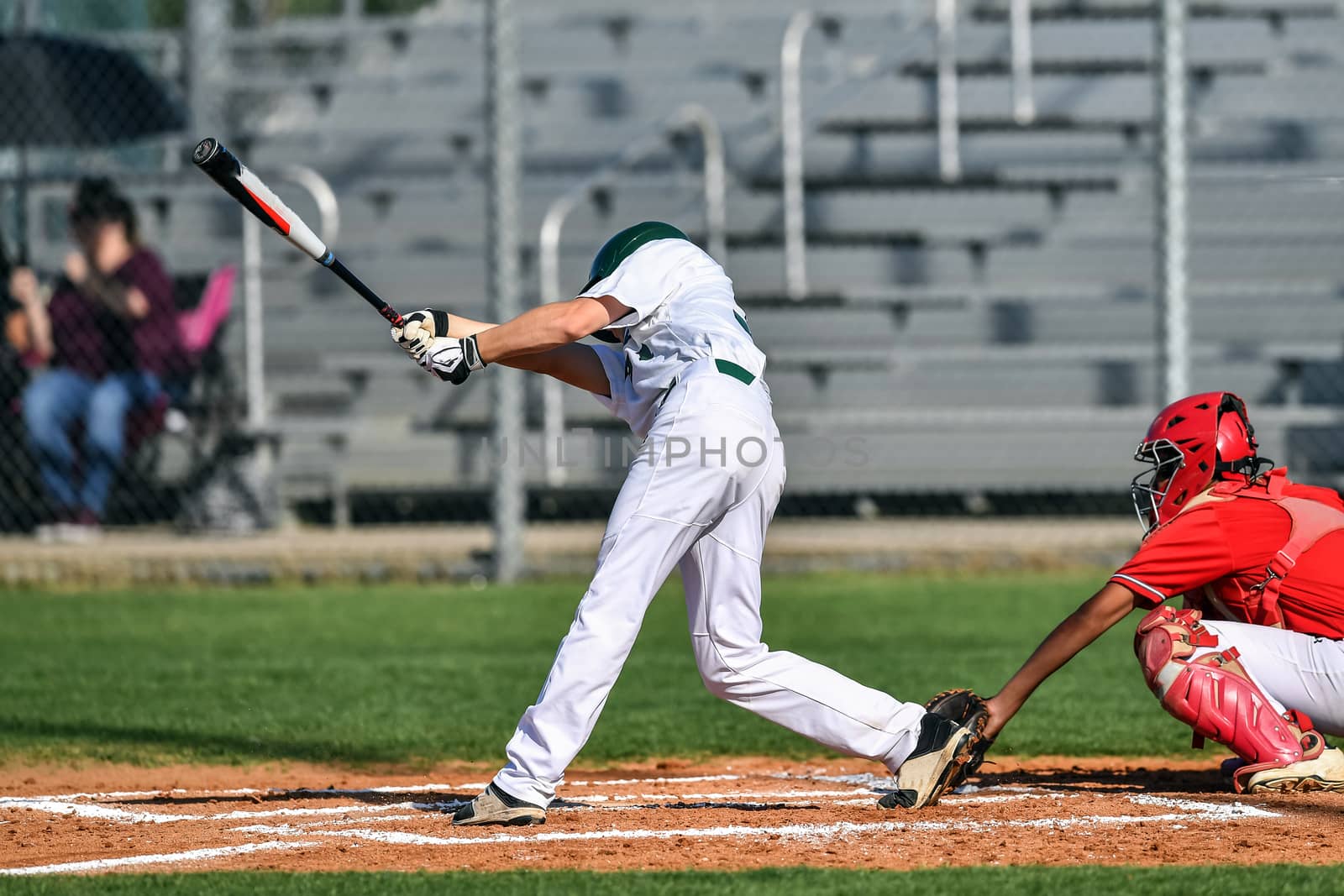 Action photo of high school baseball players making amazing plays during a baseball game