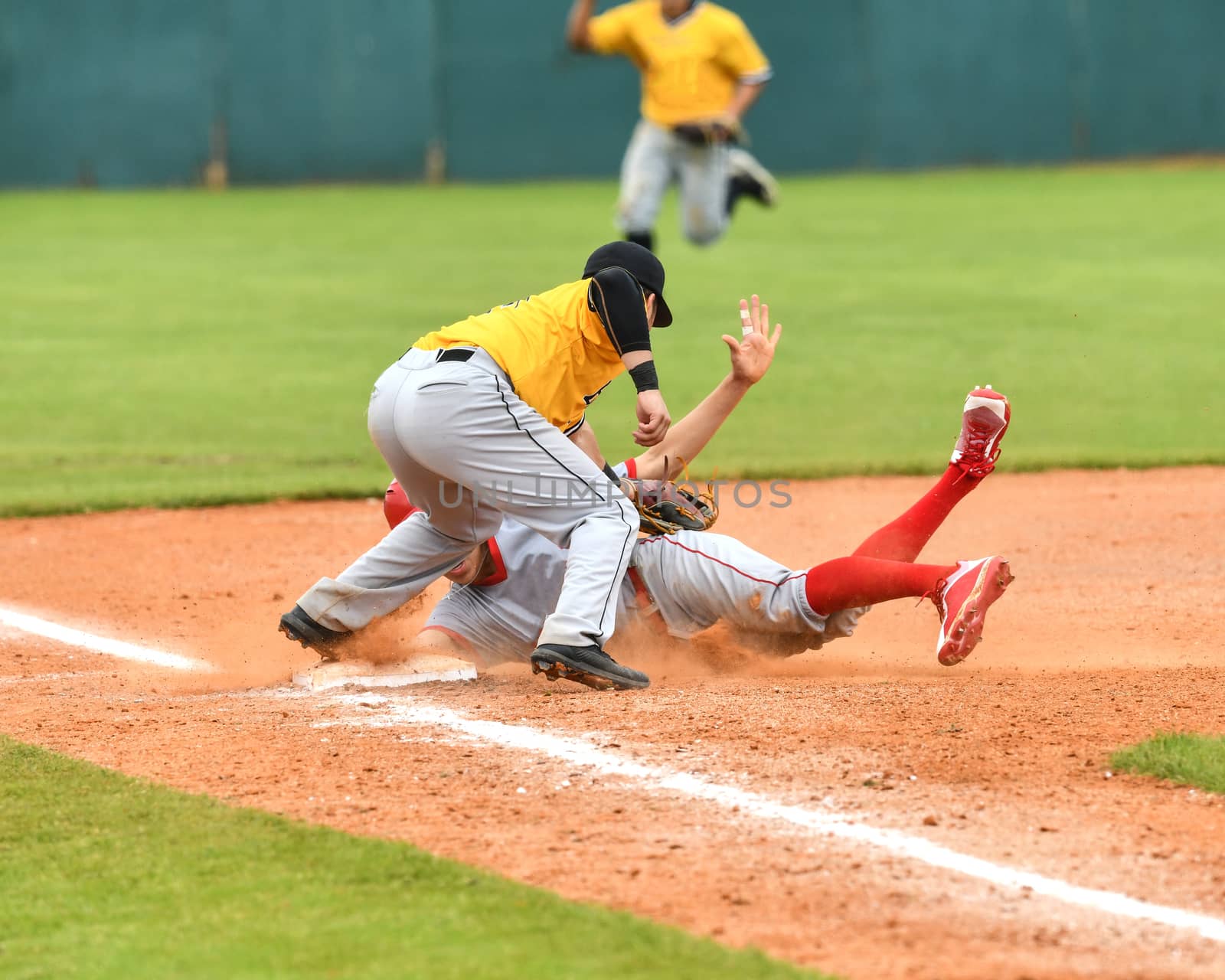 Action photo of high school baseball players making amazing plays during a baseball game